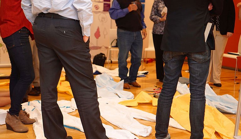 People In Design Studio With Jumpsuit On The Floor