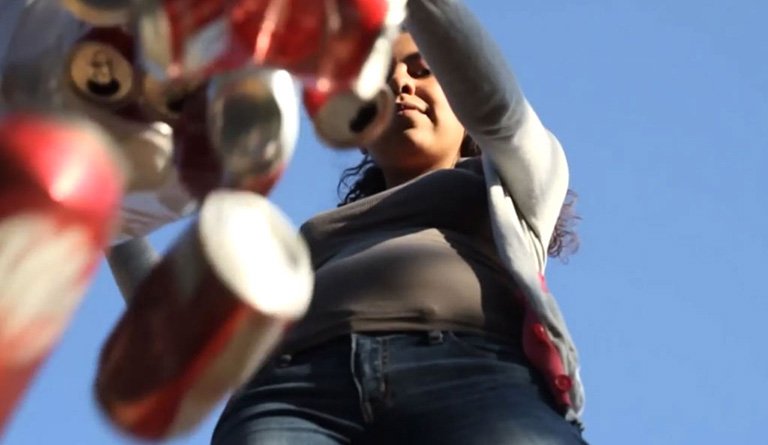 Woman Dumping Out Soda Cans