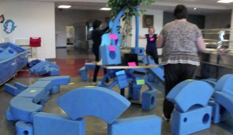 Women Standing In Cafeteria With Foam Blocks