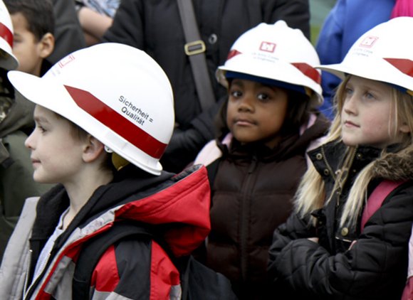 Kids In Hard Hats In A Field