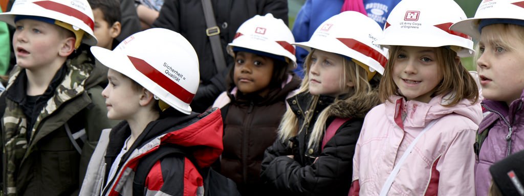 Kids In Hard Hats In A Field